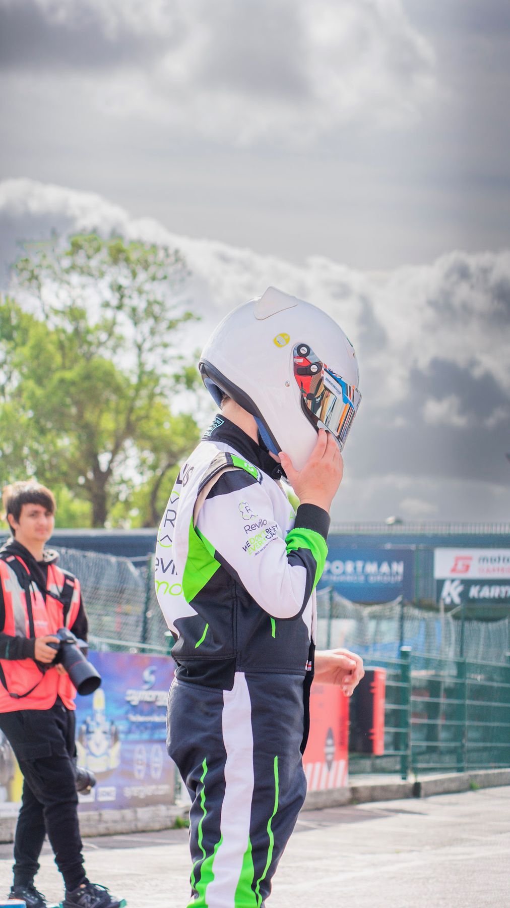 Luke putting on his helmet in the paddock