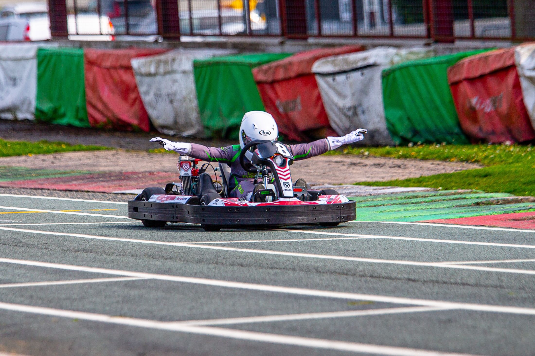 Luke celebrating with arms out as he crosses the line in kart 8